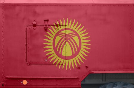 Kyrgyzstan flag depicted on side part of military armored truck close up. Army forces vehicle...