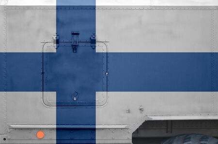 Finland flag depicted on side part of military armored truck close up. Army forces vehicle conceptual backgroundの写真素材