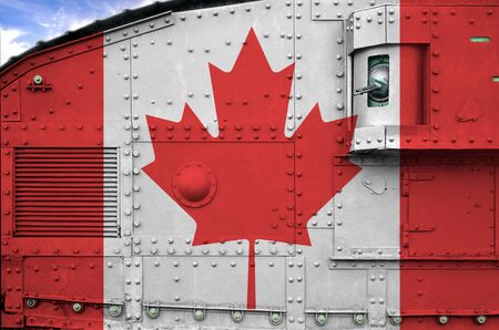 Canada flag depicted on side part of military armored tank close up. Army forces conceptual backgroundの写真素材