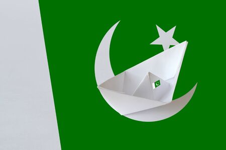 Pakistan flag depicted on paper origami ship closeup. Oriental handmade arts conceptの写真素材