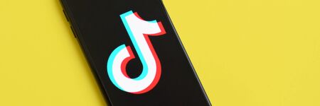 NY, USA - DECEMBER 5, 2019: Tiktok logo on samsung smartphone screen on yellow background. TikTok is a popular video-sharing social networking service owned by ByteDanceのeditorial素材