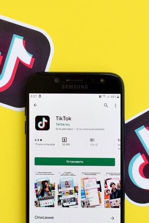 NY, USA - DECEMBER 5, 2019: Tiktok application in playmarket on samsung smartphone screen on yellow background. TikTok is a popular video-sharing social networking service owned by ByteDanceのeditorial素材