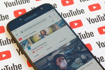 NY, USA - DECEMBER 4, 2019: Luisito Comunica official youtube channel on smartphone screen on paper youtube background.のeditorial素材