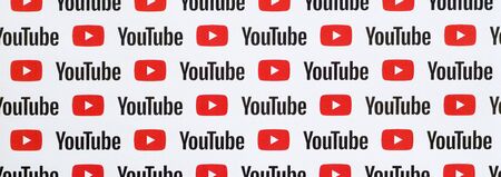 NY, USA - DECEMBER 5, 2019: Youtube pattern printed on paper with small youtube logos and...