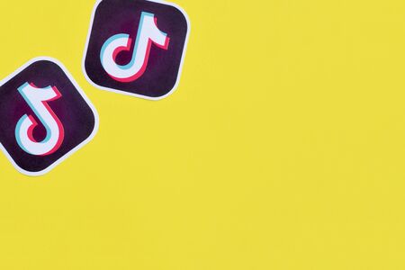 NY, USA - DECEMBER 5, 2019: Tiktok paper logo on yellow background. TikTok is a popular...
