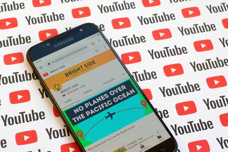 NY, USA - DECEMBER 4, 2019: Bright Side official youtube channel on smartphone screen on paper youtube background.のeditorial素材