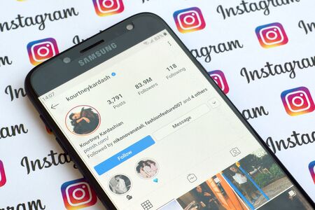 NY, USA - DECEMBER 4, 2019: Kourtney Kardashian official instagram account on smartphone screen on paper instagram banner.のeditorial素材