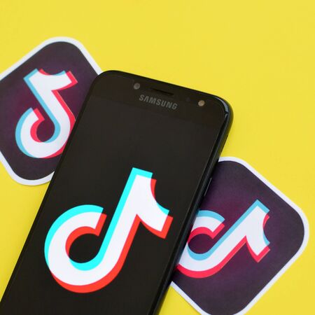NY, USA - DECEMBER 5, 2019: Tiktok logo on samsung smartphone screen on yellow background. TikTok is a popular video-sharing social networking service owned by ByteDanceのeditorial素材