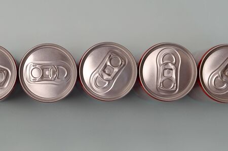 Many new aluminium cans of soda soft drink, lemonade cola, beer or energy drink containers. Drinks...