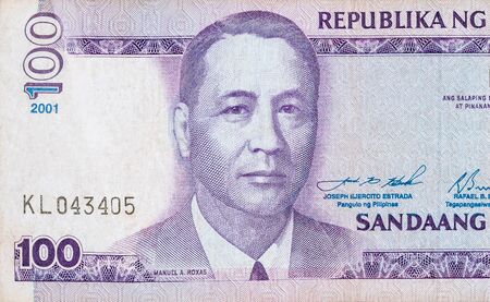 Manuel A Roxas on 100 piso Philippines money bill close up fragment. Bill of national currency of...