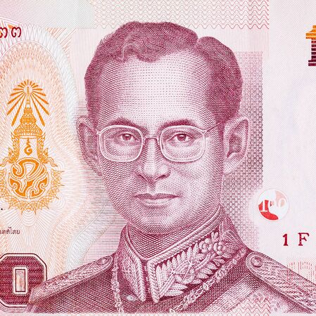 King Bhumibol Adulyadej on 100 Baht Thailand money bill close up. Bill of national currency of...
