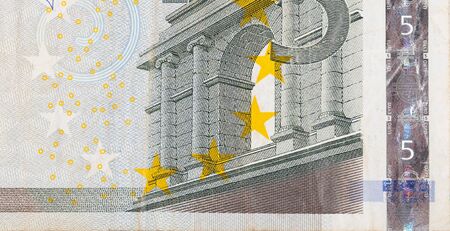 Fragment part of 5 euro banknote close-up with small brown details. European currency bill