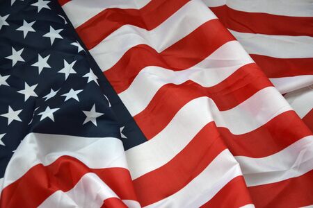 Closeup of American flag on plain background. Colorful waving horizontal US banner with stars and stripesの写真素材