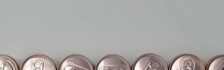 Many new aluminium cans of soda soft drink, lemonade cola, beer or energy drink containers. Drinks manufacturing concept and mass productionの写真素材