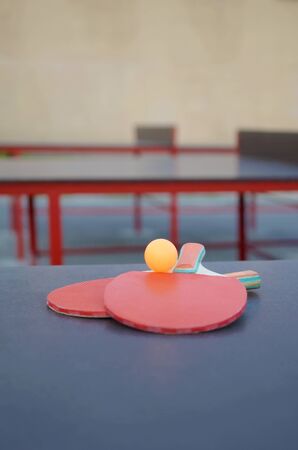 rackets and ball close up on table tennis table in outdoor sport yard. Active sports and physical training conceptの写真素材