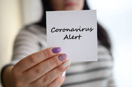 MERS-CoV Novel Corona virus inscription on paper in female hand. Middle East Respiratory Syndrome.