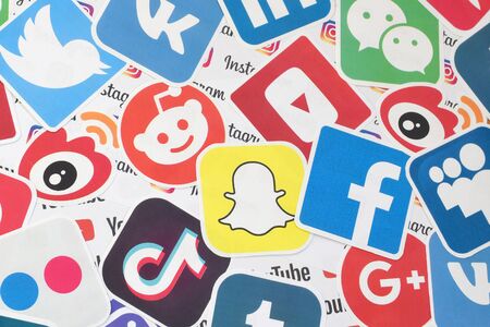 KHARKOV, UKRAINE - FEBRUARY 17, 2020: Many paper logos of popular social networks and internet resources. Colorful bannerのeditorial素材