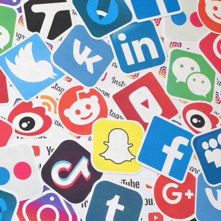 KHARKOV, UKRAINE - FEBRUARY 17, 2020: Many paper logos of popular social networks and internet resources. Colorful bannerのeditorial素材