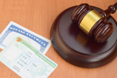 Justice mallet and United States Social Security SSN number and Permanent resident green card from DV-lottery close upの写真素材