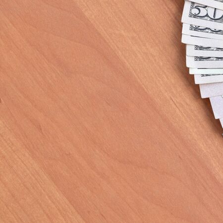 Fan of many one hundred and fifty dollar bills on wooden background surface close up. Flat lay top...