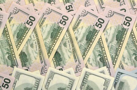 Many one hundred and fifty dollar bills on flat background surface close up. Flat lay top view....