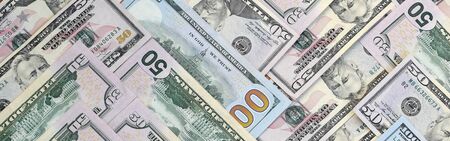 Many one hundred and fifty dollar bills on flat background surface close up. Flat lay top view....