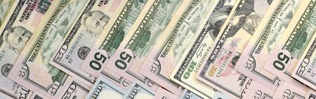 Many one hundred and fifty dollar bills on flat background surface close up. Flat lay top view....