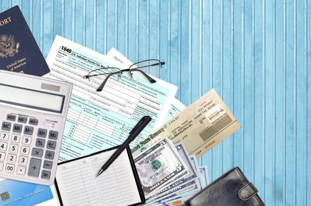 IRS form 1040 U.S. Individual income tax return with refund check lies on flat lay office table and ready to fill. U.S. Internal revenue services paperwork concept. Time to pay taxes in United Statesの写真素材