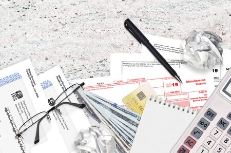 IRS form 1099-MISC Miscellaneous income lies on flat lay office table and ready to fill. U.S....