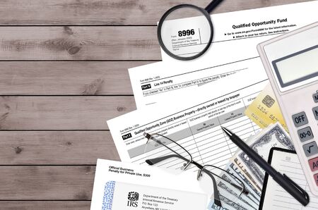 IRS form 8996 Qualified opportunity fund lies on flat lay office table and ready to fill. U.S....