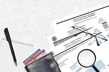 USCIS form I-9 Employment eligibility verification lies on flat lay office table and ready to fill....