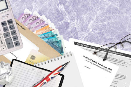English Tax form sa900 Trust and estate tax return 2020 from HM revenue and customs lies on table...