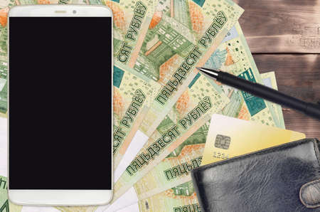 50 Belorussian rubles bills and smartphone with purse and credit card. E-payments or e-commerce...