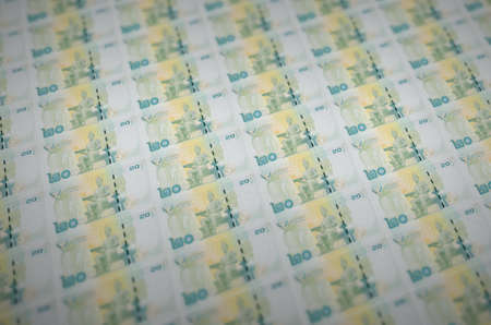 20 Thai Baht bills printed in illegal money production conveyor. Collage of many fake bills. Concept of counterfeitters mass workの写真素材