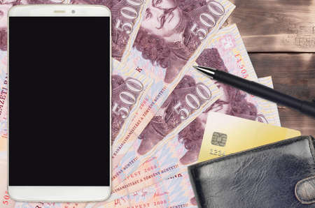 500 Hungarian forint bills and smartphone with purse and credit card. E-payments or e-commerce concept. Online shopping and business with portable devices usageの写真素材