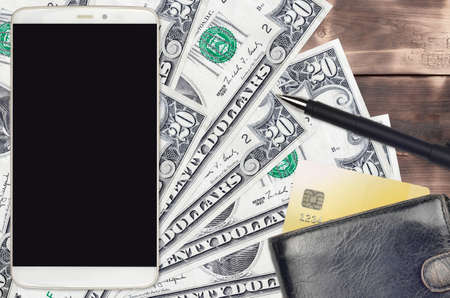 20 US dollars bills and smartphone with purse and credit card. E-payments or e-commerce concept. Online shopping and business with portable devices usageの写真素材