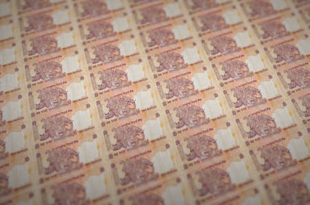 10 Indian rupees bills printed in illegal money production conveyor. Collage of many fake bills....