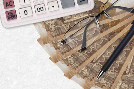 2000 Hungarian forint bills fan and calculator with glasses and pen. Business loan or tax payment...