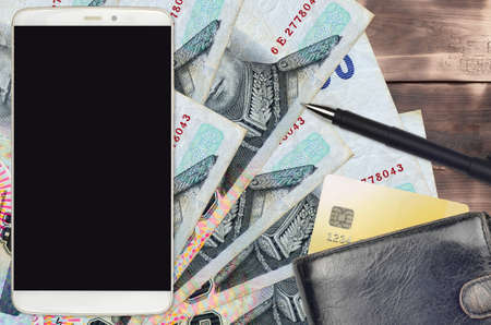 50 Thai Baht bills and smartphone with purse and credit card. E-payments or e-commerce concept. Online shopping and business with portable devices usageの写真素材
