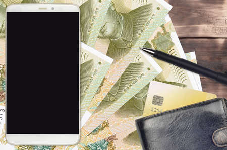 1 Chinese yuan bills and smartphone with purse and credit card. E-payments or e-commerce concept....