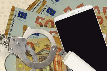 50 euro bills and smartphone with police handcuffs. Concept of hackers phishing attacks, illegal scam or online spyware soft distributionの写真素材