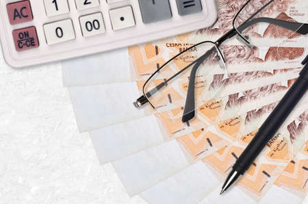 200 Czech korun bills fan and calculator with glasses and pen. Business loan or tax payment season...