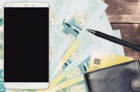 20 Thai Baht bills and smartphone with purse and credit card. E-payments or e-commerce concept. Online shopping and business with portable devices usageの写真素材