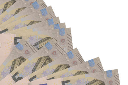 5 euro bills lies isolated on white background with copy space stacked in fan close up. Payday time...