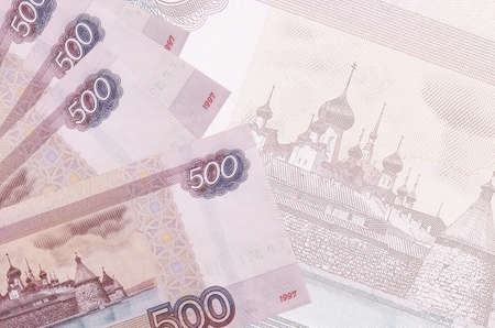 500 russian rubles bills lies in stack on background of big semi-transparent banknote. Abstract business background with copy spaceの写真素材