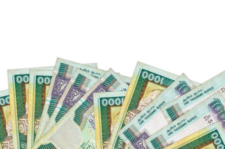 1000 Sri Lankan rupees bills lies on bottom side of screen isolated on white background with copy...