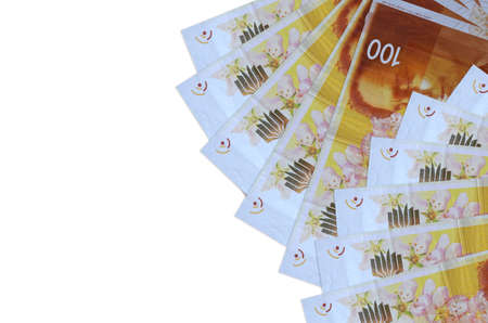 100 Israeli new shekels bills lies isolated on white background with copy space. Rich life...