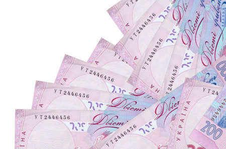 200 Ukrainian hryvnias bills lies in different order isolated on white. Local banking or money...