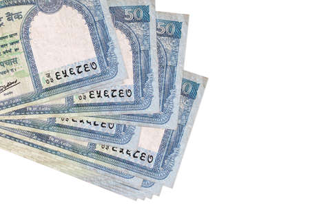 50 Nepalese rupees bills lies in small bunch or pack isolated on white. Mockup with copy space....