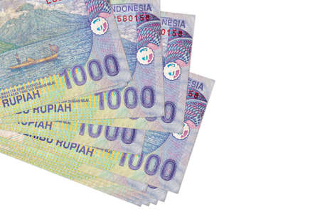 1000 Indonesian rupiah bills lies in small bunch or pack isolated on white. Mockup with copy space....